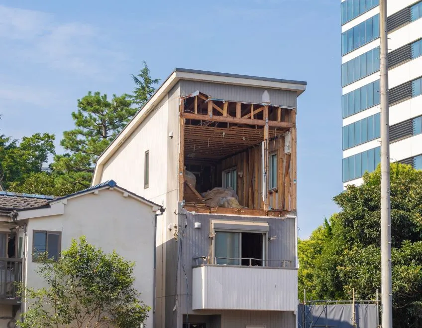 A multi-story building undergoing professional interior and selective demolition in Dallas, showing exposed structural framing and debris removal.
